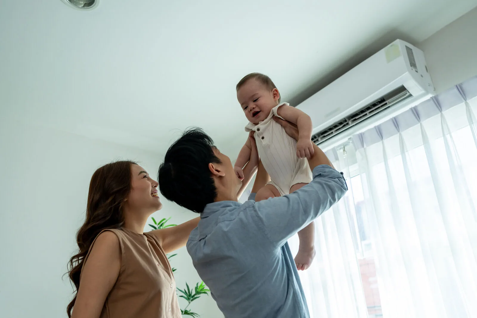 Happy family enjoying comfortable home temperature