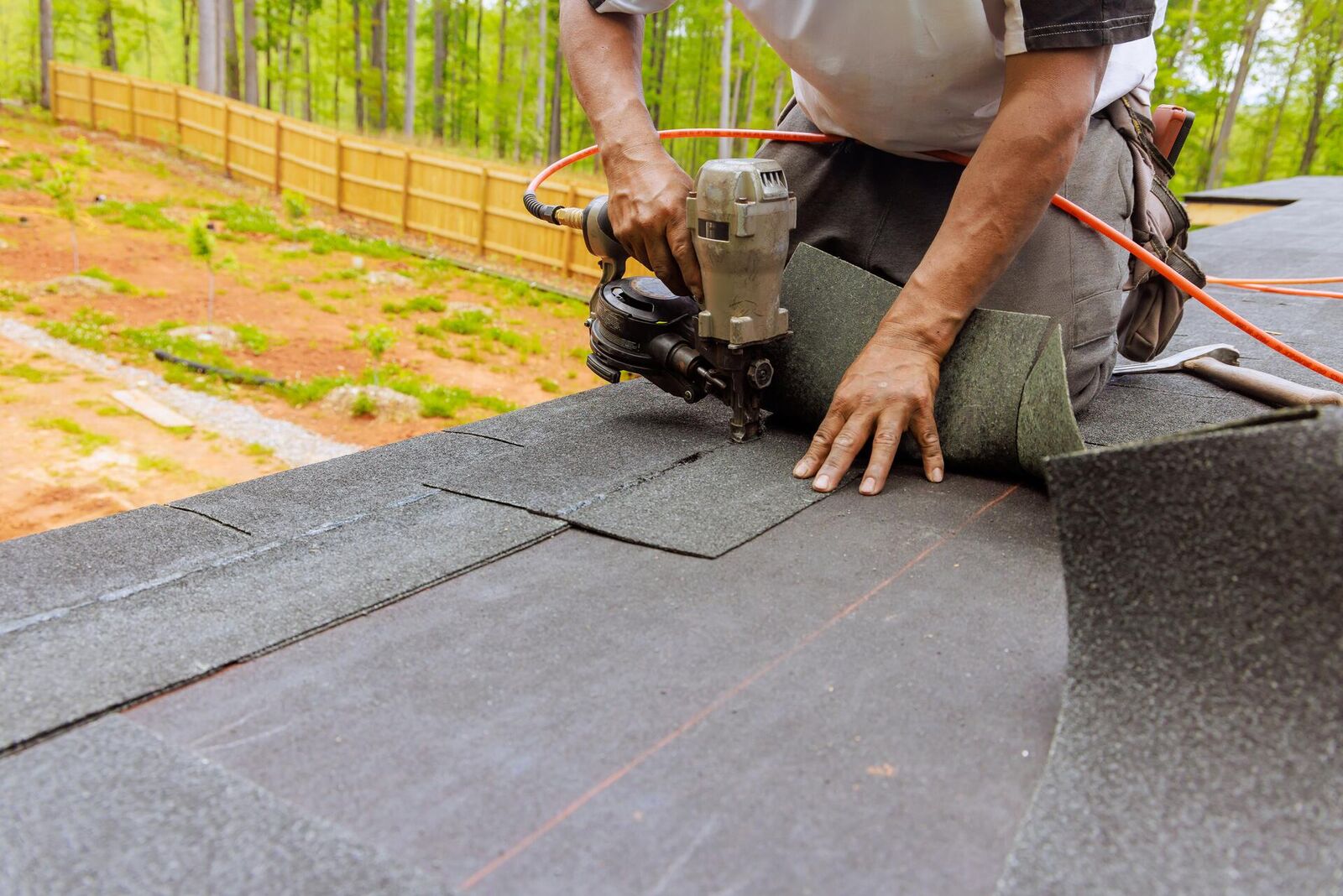 Roofer installing new shingles on a residential home